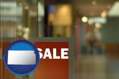 kansas map icon and a department store display advertisement